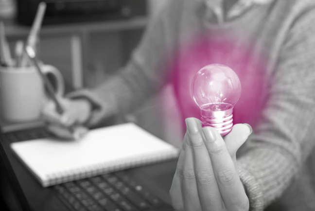 Hand holding a lightbulb